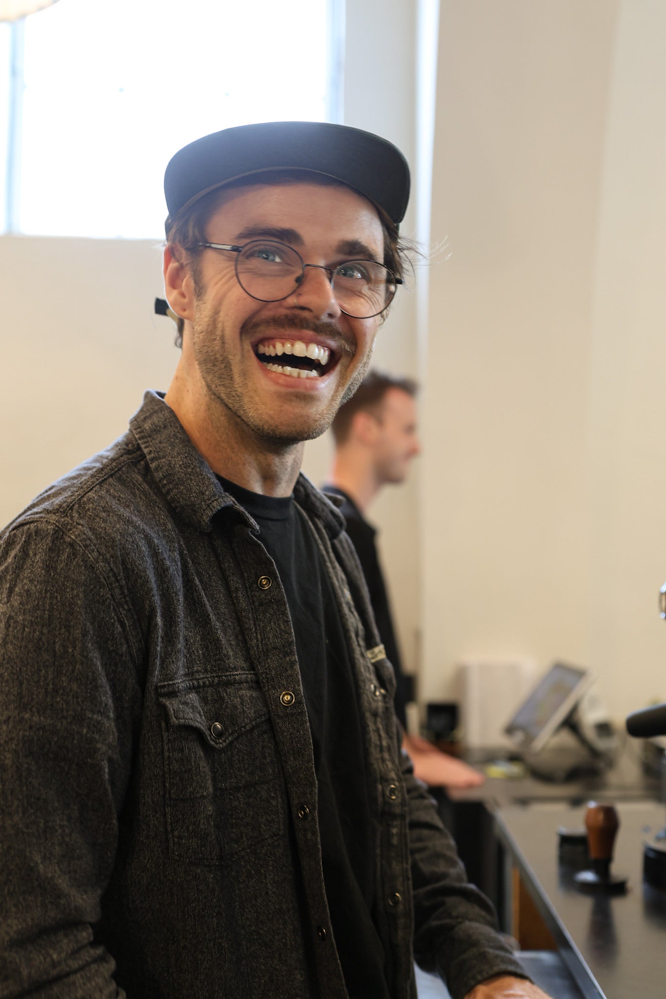 barista smiling at Origin Coffee Bar, Savannah, GA | Specialty Coffee Roaster and Cafe