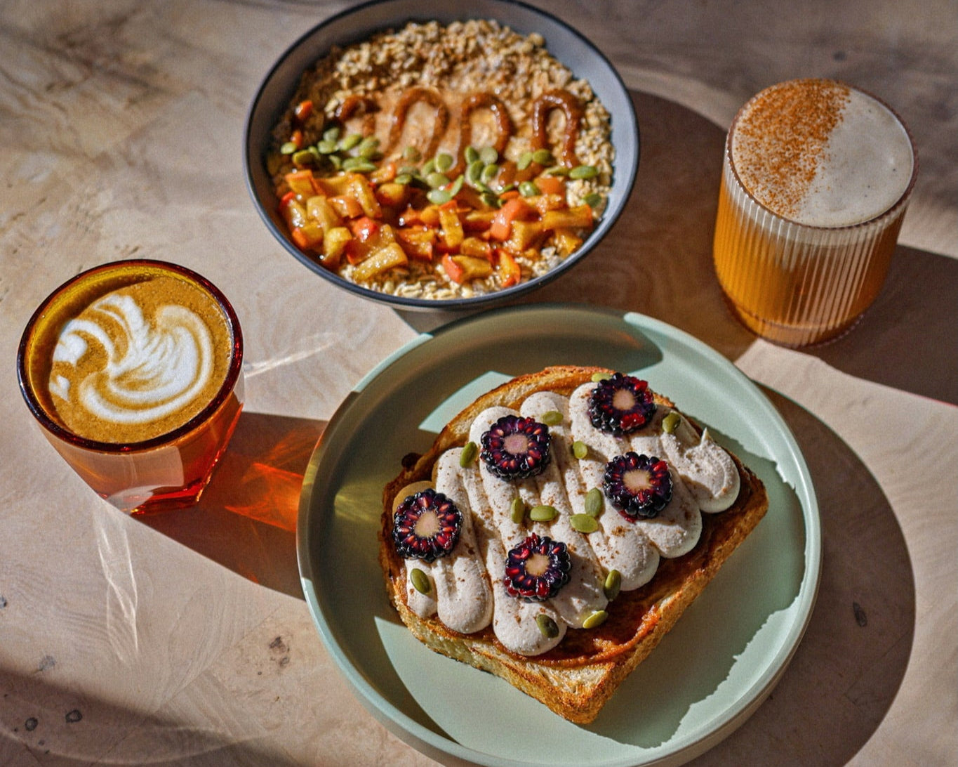 Breakfast setting with toast, salad, and drinks on a marble surface. Fall seasonal menu.